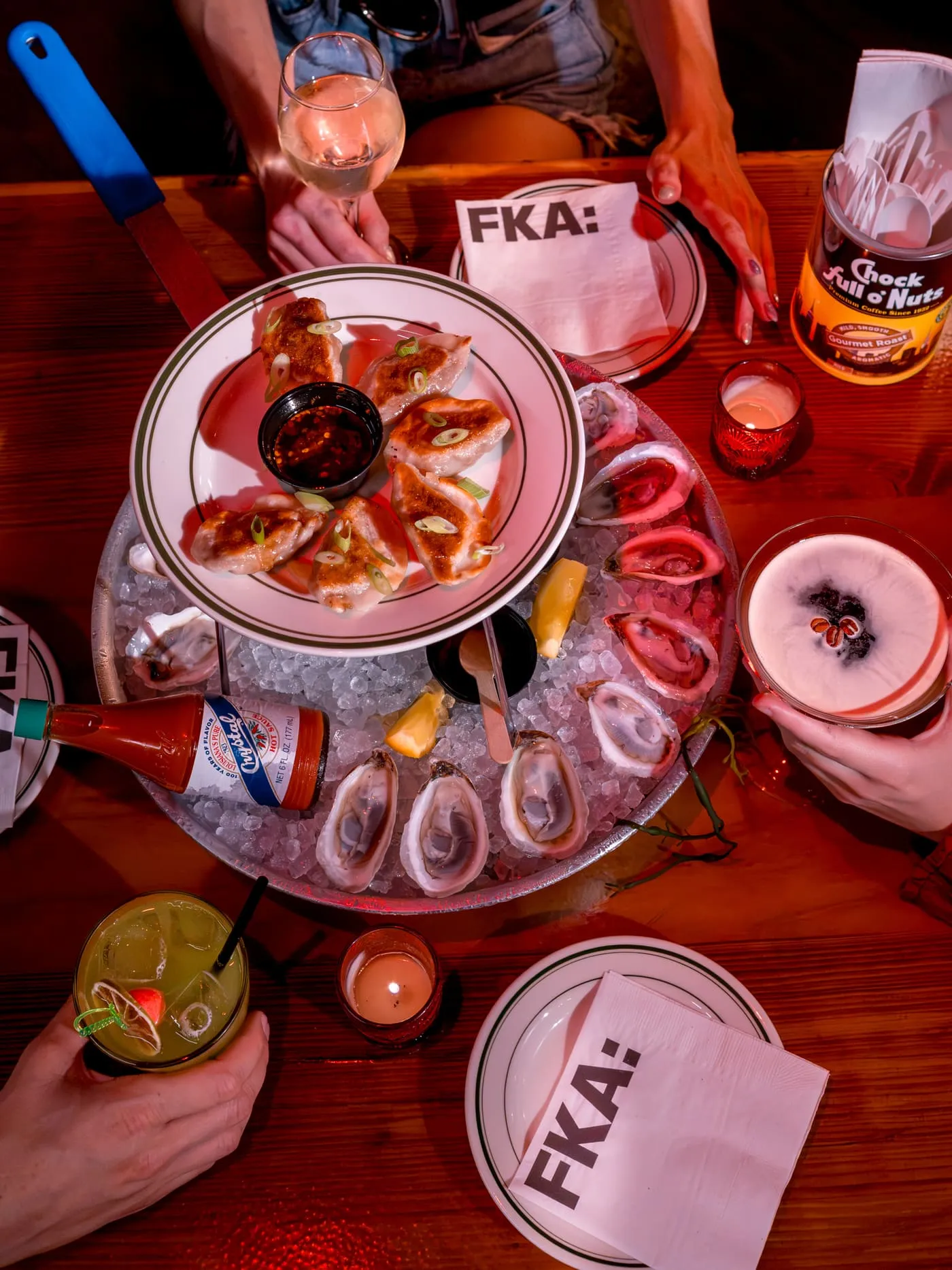 Oysters + Dumplings at FKA: Formerly Known As: pan-fried dumplings set over a tray of oysters on ice, with an espresso martini