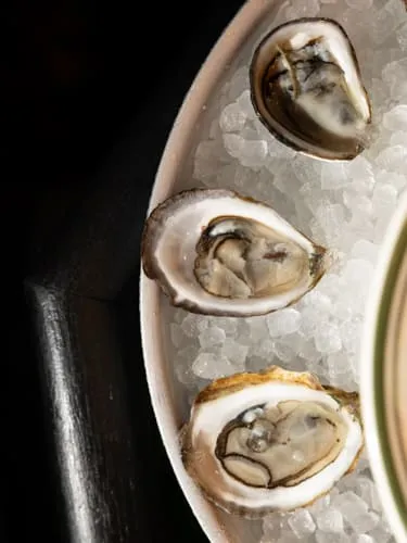 Three oysters on crushed ice at FKA: Formerly Known As