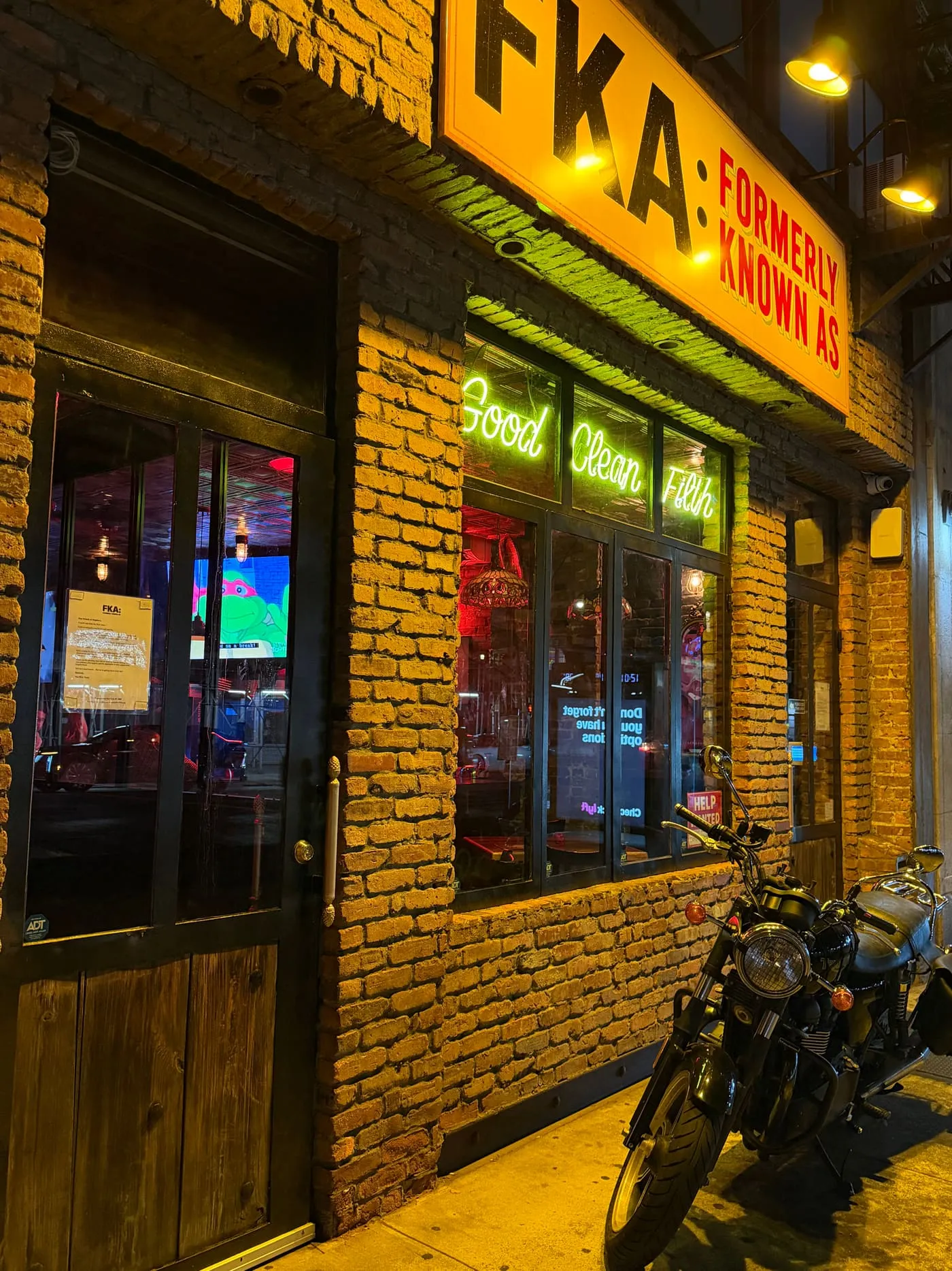 Night portrait of the FKA: Formerly Known As storefront at 221 2nd Avenue